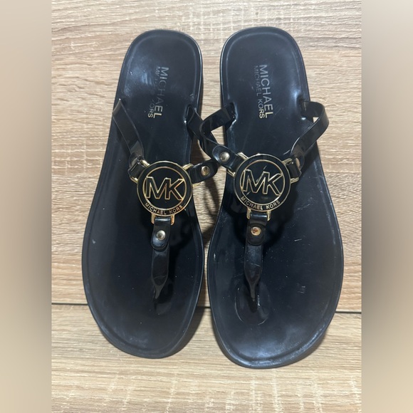 Michael Kors Shoes - Michael Kors Sandals Black Gold Emblem logo charm women’s size 9 shoes flip flop